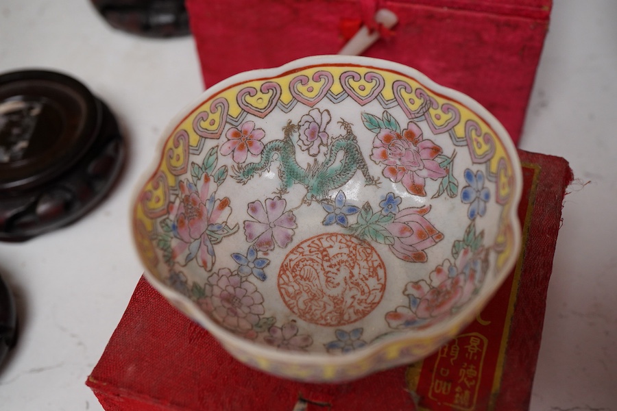 A collection of late 20th century Chinese boxed eggshell bowls, and four wood stands